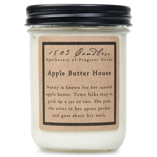 White candle jar with black lid and kraft paper label that reads Apple Butter House