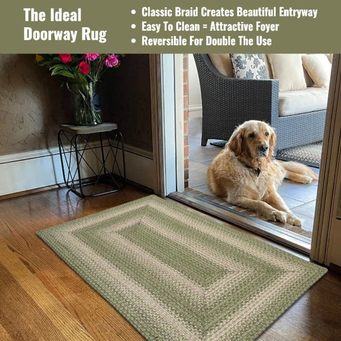 a golden retriever lays on the porch in the open doorway with a rug in shades of green in the doorway.