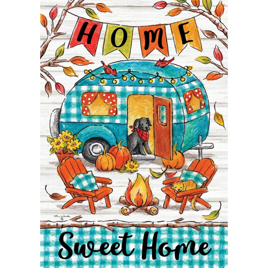 Garden flag with white shiplap background and a blue camper with a black dog in the center. A banner reading home at the top, with branches and leaves, and blue and white check border at the bottom reads Sweet Home