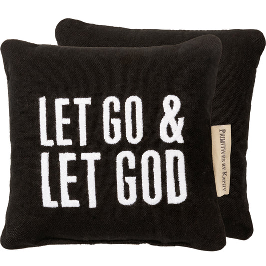 small 6" x 6" black pillow with white lettered embroidery reads "Let Go & Let God"