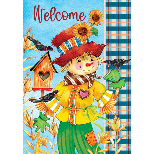 garden flag with blue background and a cheerful scarecrow with a hat and sunflowers. Crows sit on each hand, and corn stalks grow in the front. 