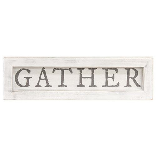 White framed sign that says Gather in gray lettering