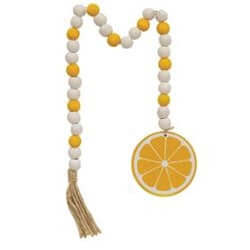 yellow and white bead garlands with a tassel and painted wood lemon slice