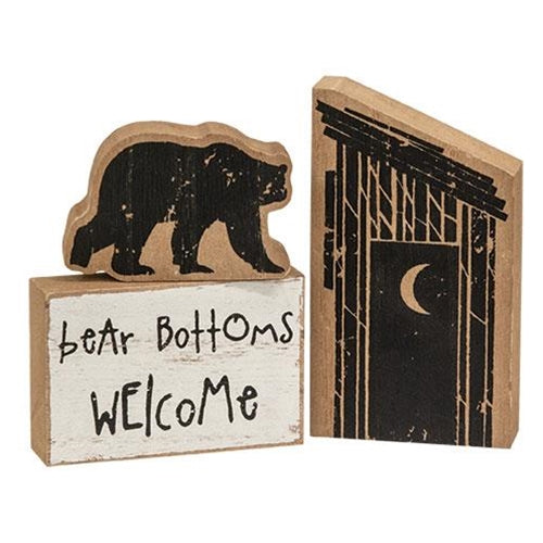 3 wood blocks with an outhouse block, a black bear cutout, and a block that says bear bottoms welcome