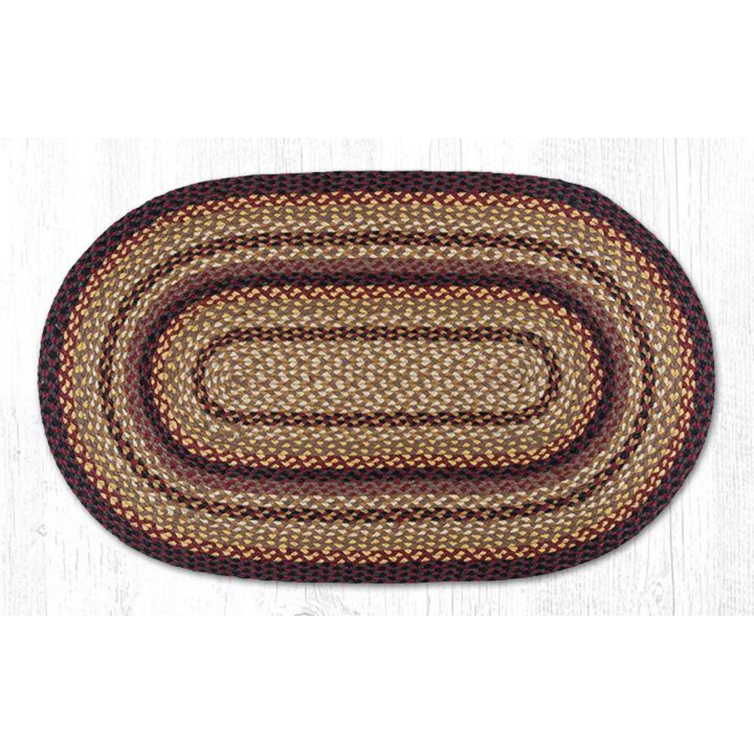 white background with oval rug in dark red, cream, and mustard