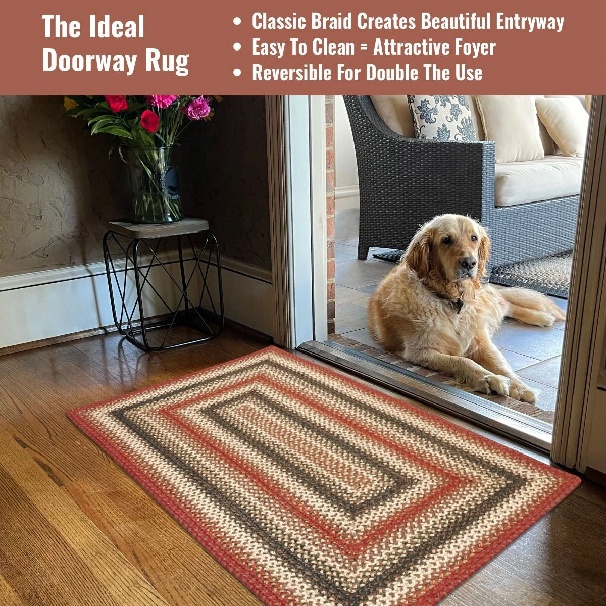 A golden retriever lays on the porch wtih a rectangle braided rug in colors of rust, green, and cream, in the doorway.