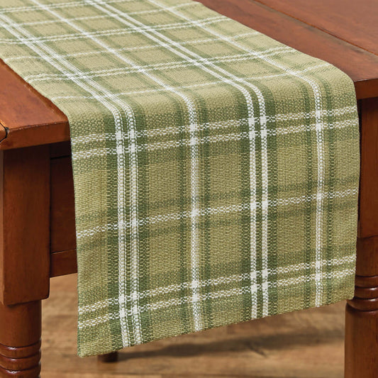 flat weave table hemmed table runner in shades of green plaid with white